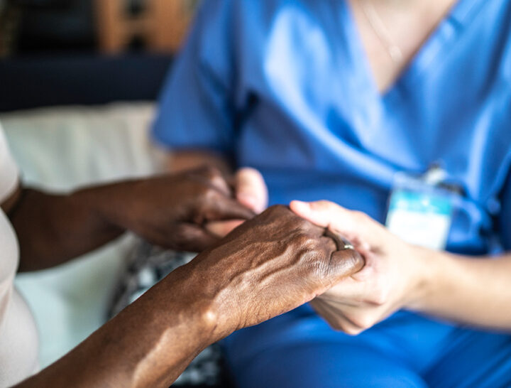 close up of caregiver holding patient hands