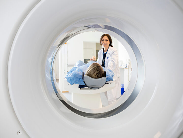 tech helping person into MRI machine