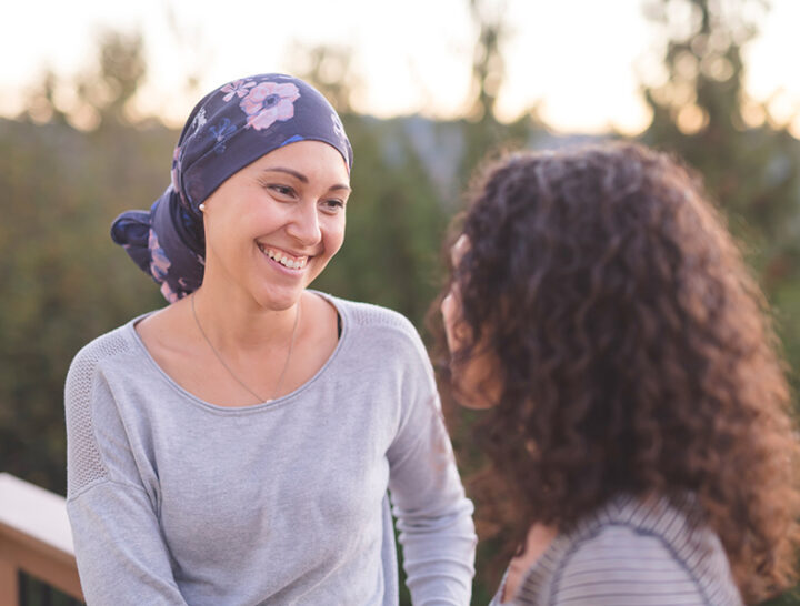 woman with cancer speaking with friend