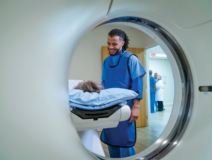tech helping patient during scans