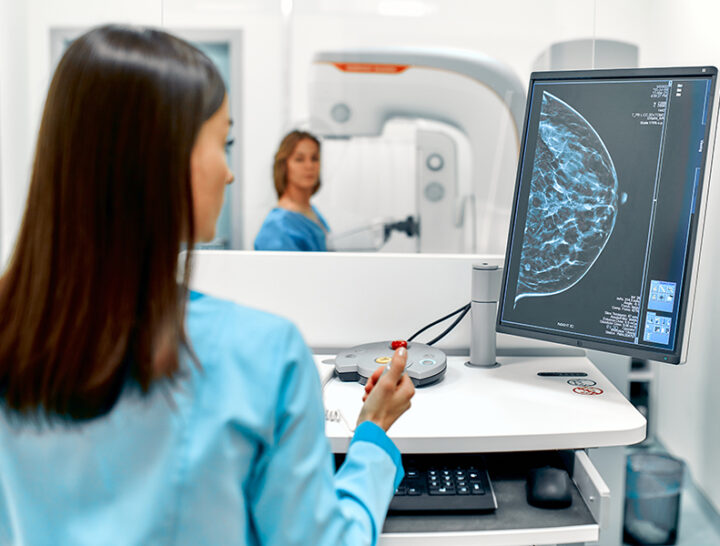 tech looking at screen during mammogram