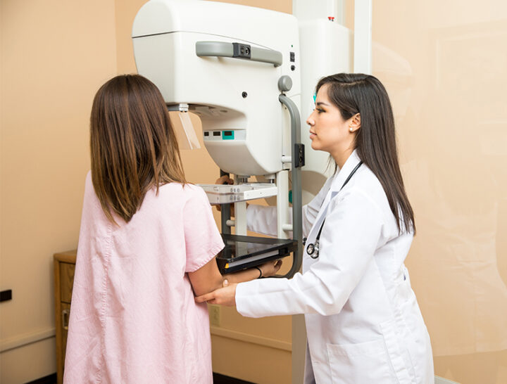 tech helping woman during mammogram