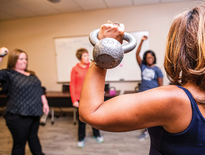 woman holding kettle bell during therapy